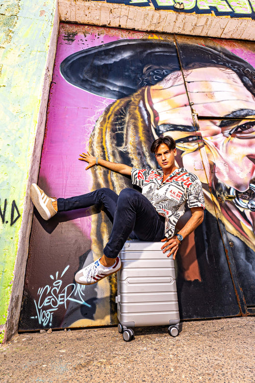 Man using a Hand Cabin Aluminum Luggage SILVER OSAKA