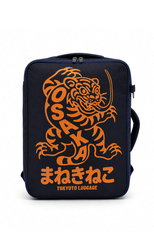 A navy blue Tokyo Luggage bag featuring a large orange graphic of a tiger and the word 'OSAKA' in stylized lettering, with Japanese characters and 'TOKYO LUGGAGE' printed below, shown against a plain white background.